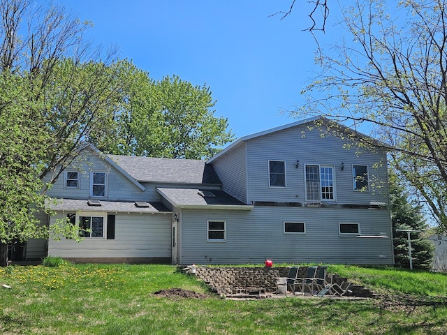 412 Prairie Ave, Faribault, MN 55021 - rear view of house featuring a lawn and roof with shingles