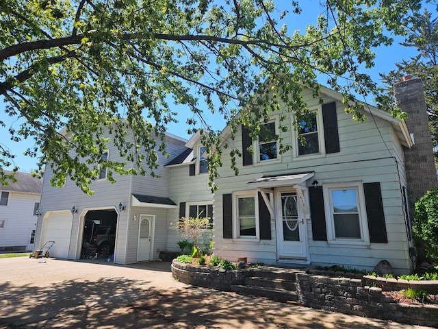 412 Prairie Ave, Faribault, MN 55021 - view of front of property with a garage, concrete driveway, and a chimney