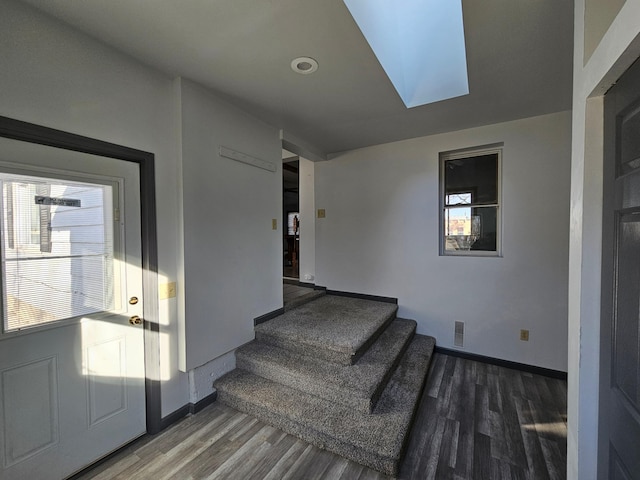 412 Prairie Ave, Faribault, MN 55021 - stairs with wood finished floors, baseboards, a skylight, and plenty of natural light