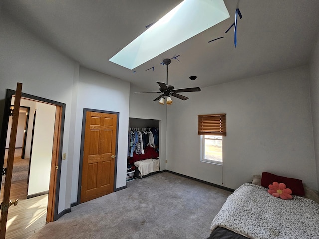 412 Prairie Ave, Faribault, MN 55021 - bedroom featuring carpet floors, a skylight, a closet, baseboards, and lofted ceiling