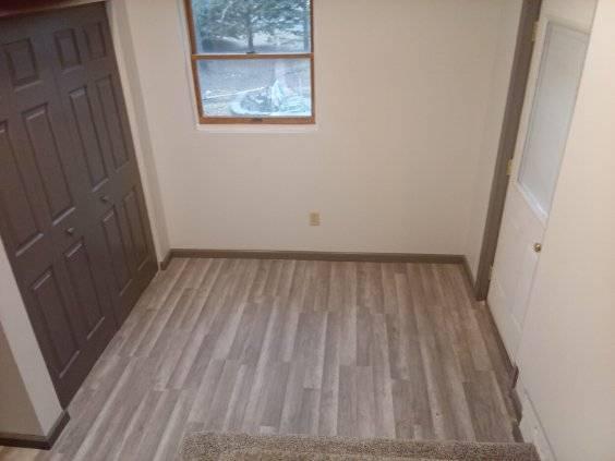 412 Prairie Ave, Faribault, MN 55021 - unfurnished bedroom with light wood-style floors and baseboards