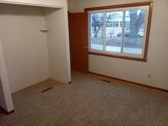 412 Prairie Ave, Faribault, MN 55021 - spare room featuring baseboards and carpet flooring