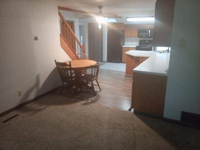 412 Prairie Ave, Faribault, MN 55021 - dining area featuring stairway, a ceiling fan, and light wood-style flooring