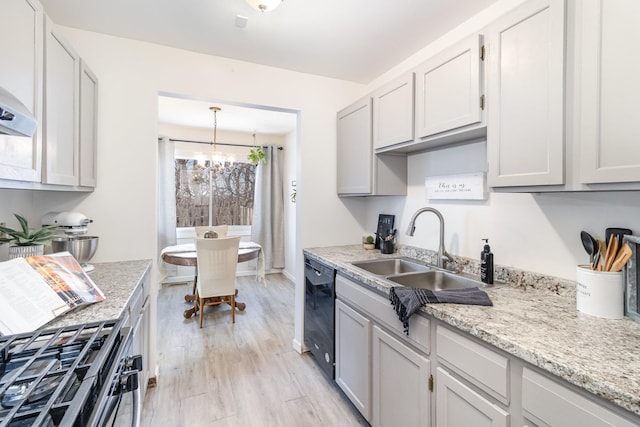 kitchen with a chandelier, light hardwood / wood-style floors, stainless steel range with gas cooktop, sink, and black dishwasher