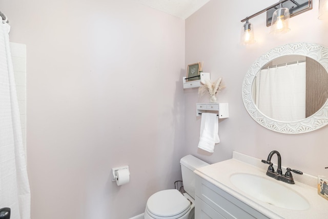 bathroom featuring toilet and vanity