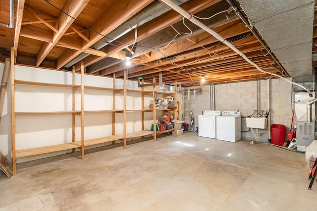 basement with washing machine and dryer and sink