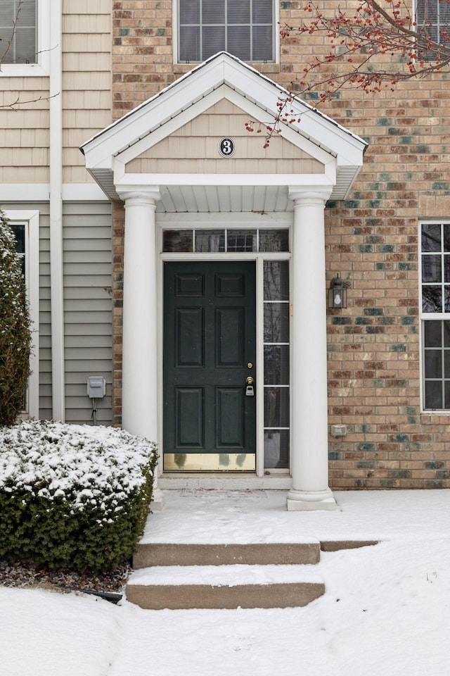 view of snow covered property entrance