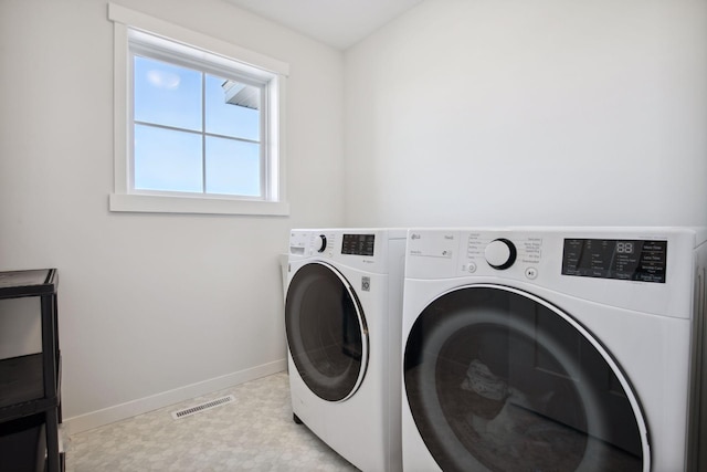 washroom featuring washer and clothes dryer