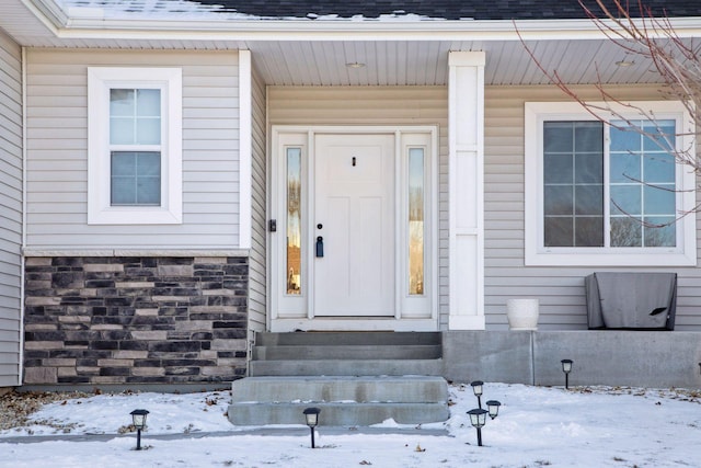 view of snow covered property entrance