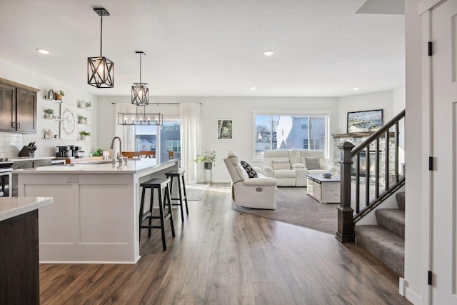 kitchen featuring dark wood-type flooring, sink, pendant lighting, and plenty of natural light