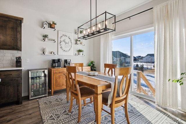 dining space featuring dark wood-type flooring and wine cooler