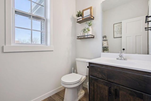 bathroom featuring wood-type flooring, toilet, and vanity