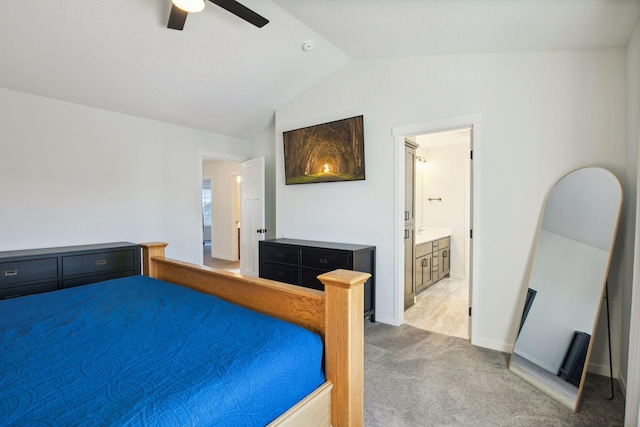 carpeted bedroom featuring ceiling fan, ensuite bath, and vaulted ceiling