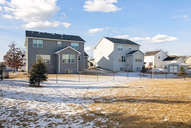 view of snow covered rear of property