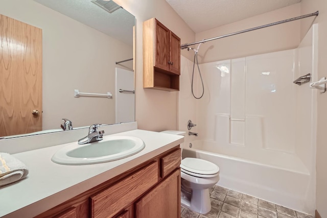 full bathroom with washtub / shower combination, a textured ceiling, toilet, and vanity