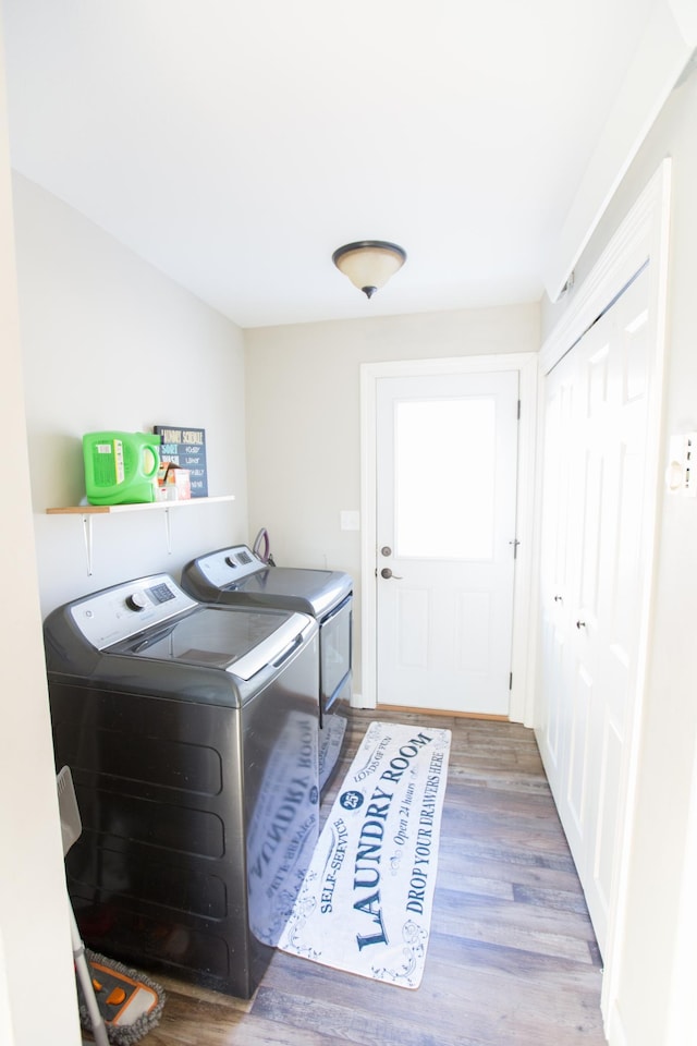 laundry room featuring washer and dryer and wood-type flooring