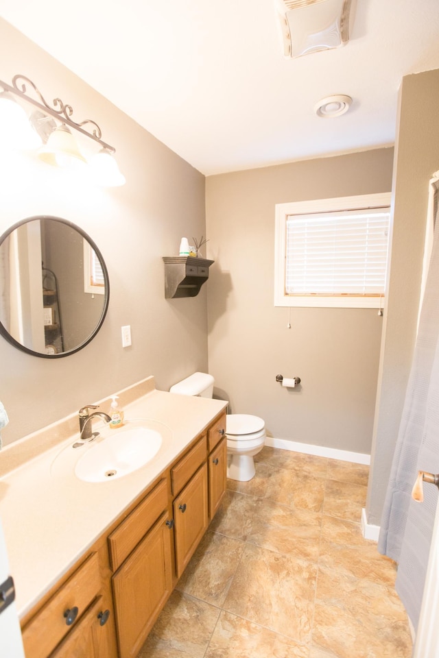 bathroom featuring toilet and vanity