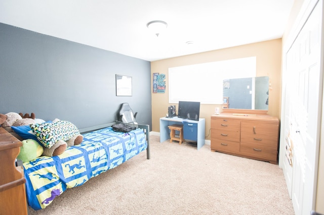 bedroom featuring light colored carpet and a closet