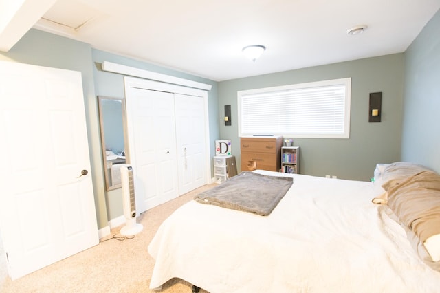 bedroom with a closet and light carpet