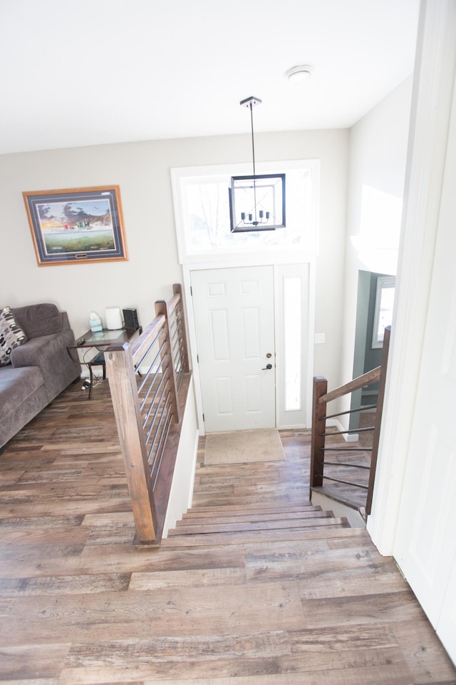 entrance foyer featuring an inviting chandelier and light hardwood / wood-style flooring