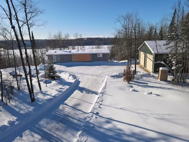 yard covered in snow with a garage