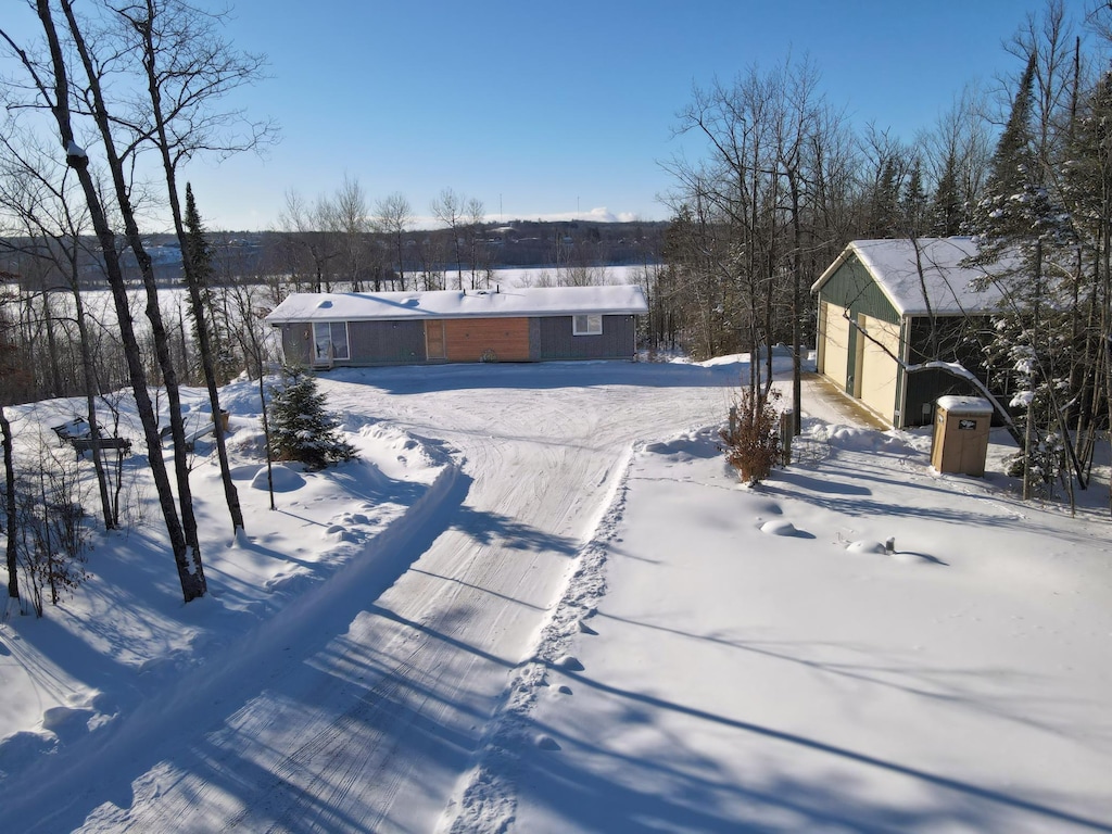 yard covered in snow featuring a garage