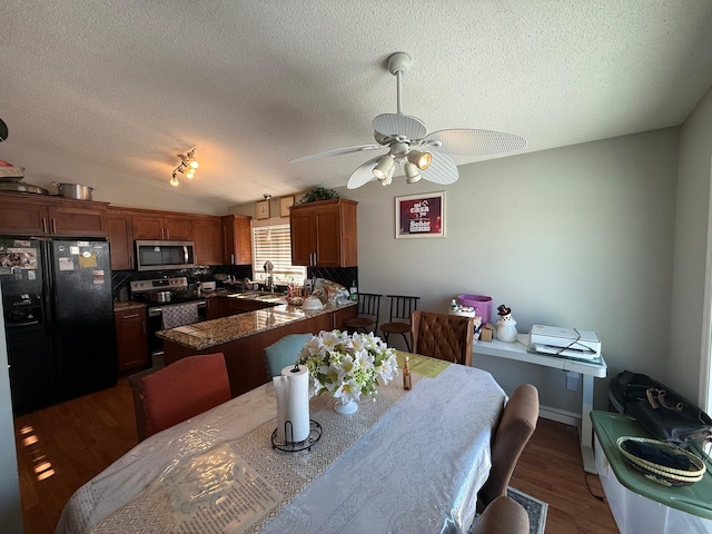 dining space featuring ceiling fan, a textured ceiling, dark hardwood / wood-style flooring, and lofted ceiling