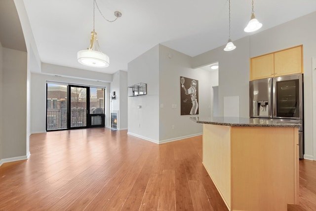 500 Grant St Unit 204, Minneapolis, MN 55404 - kitchen featuring a kitchen island, light brown cabinets, light wood-style floors, and stainless steel fridge