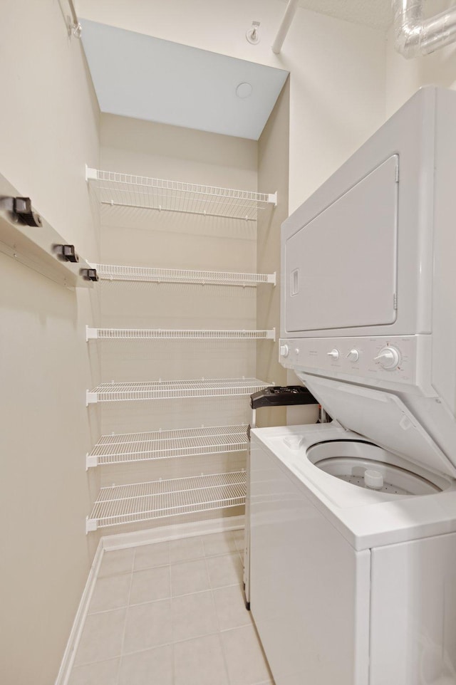 500 Grant St Unit 204, Minneapolis, MN 55404 - washroom with stacked washer and clothes dryer and light tile patterned floors