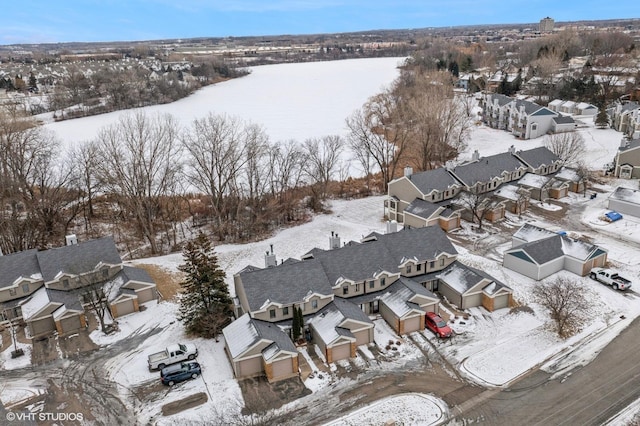 snowy aerial view with a residential view