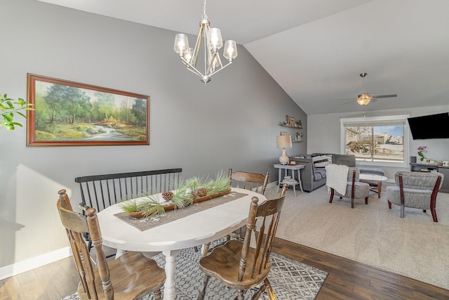 dining room with vaulted ceiling, dark hardwood / wood-style flooring, and ceiling fan with notable chandelier