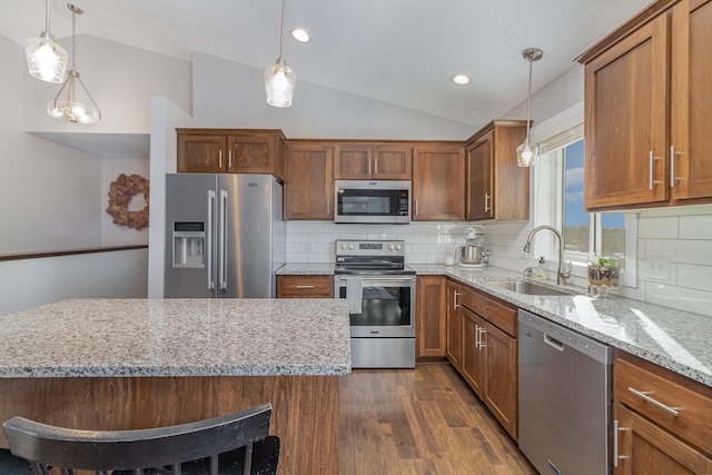 kitchen with sink, backsplash, appliances with stainless steel finishes, and vaulted ceiling