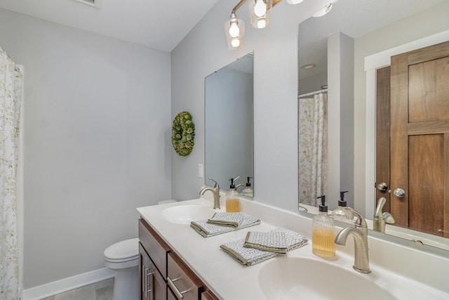 bathroom featuring tile patterned floors, toilet, and vanity