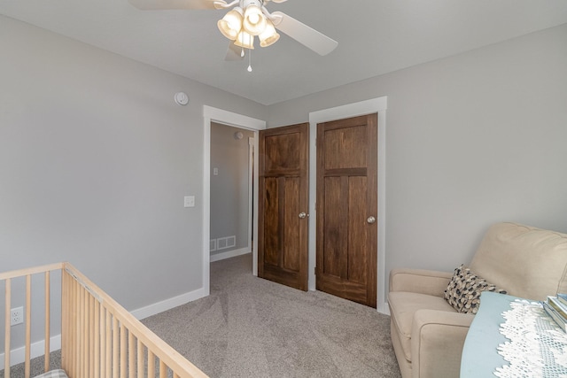 sitting room featuring ceiling fan and carpet