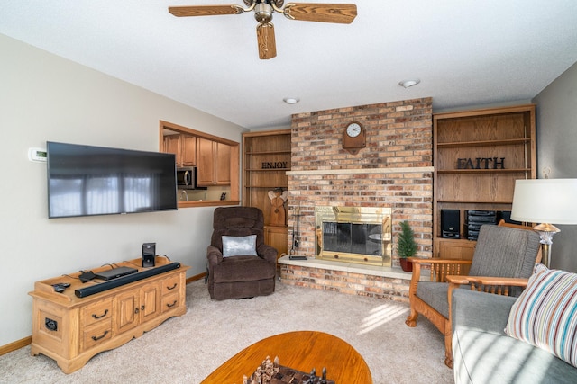 carpeted living room with ceiling fan and a fireplace