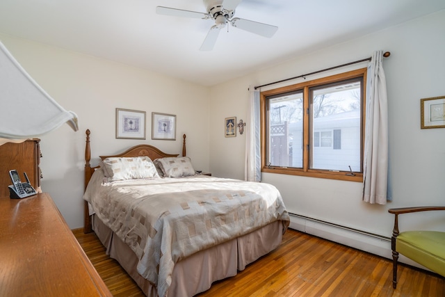 bedroom with hardwood / wood-style flooring, ceiling fan, and baseboard heating