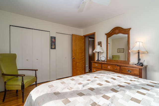 bedroom with multiple closets, ceiling fan, and light hardwood / wood-style floors