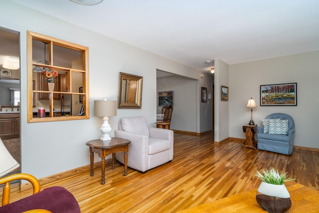 living room with light wood-type flooring and sink