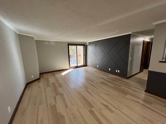 spare room featuring crown molding and light hardwood / wood-style floors