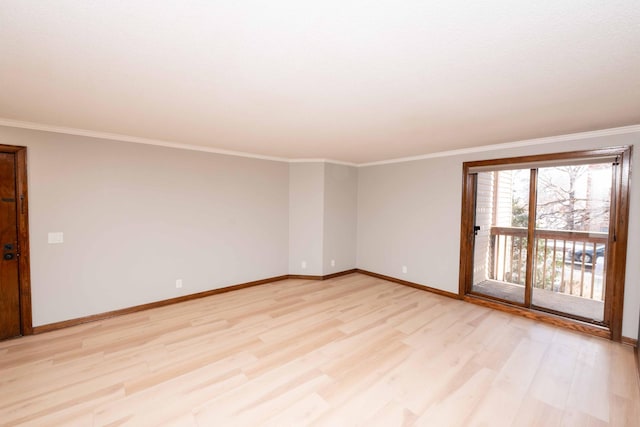 empty room with baseboards, crown molding, and light wood-style floors