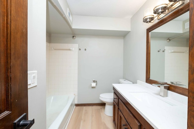 full bathroom with visible vents, toilet, shower / tub combination, wood finished floors, and vanity