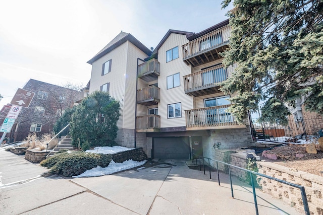 1720 3rd Ave S Unit 101, Minneapolis, MN 55404 - view of building exterior with driveway and an attached garage