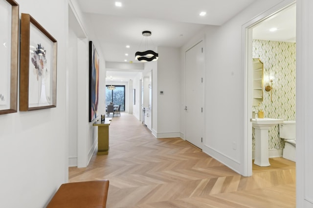 hall featuring light parquet flooring and sink