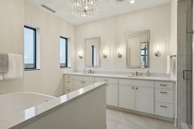 bathroom with an inviting chandelier, an enclosed shower, and vanity