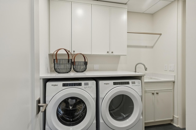 laundry room with sink, cabinets, and washer and dryer