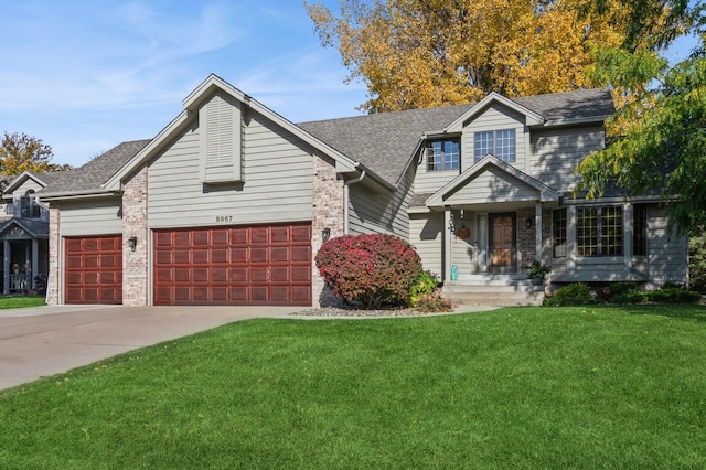 view of front of house featuring a front yard and a garage