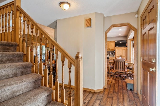 staircase with wood-type flooring