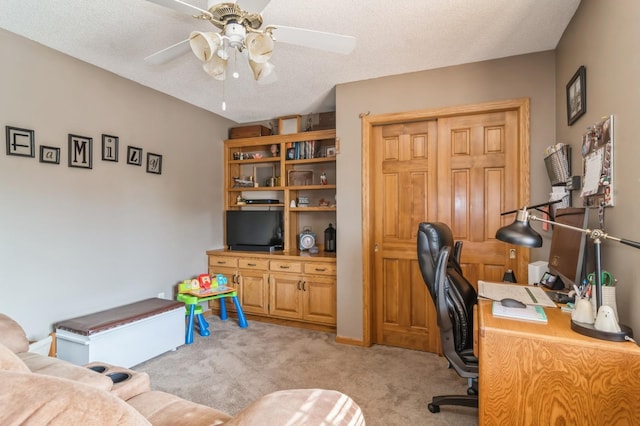 office with ceiling fan, a textured ceiling, and light carpet