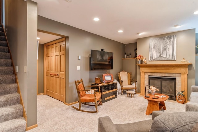 living room featuring a fireplace and carpet