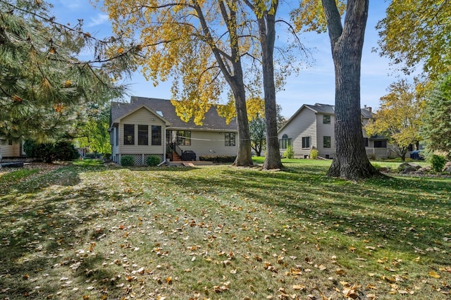 back of house with a lawn